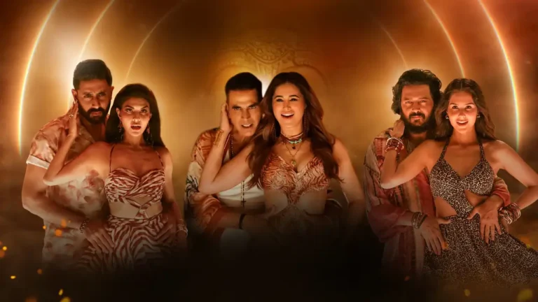 The cast of Housefull 5, including Riteish Deshmukh, Jacqueline Fernandez, Akshay Kumar, and two other female actors, posing together against a warm, glowy background.